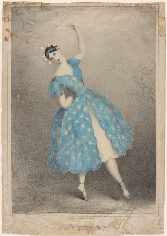 A female ballet dancer in a blue star-patterned dress stands en relevé with one arm raised overhead, her head tilted back in a dreamy expression.