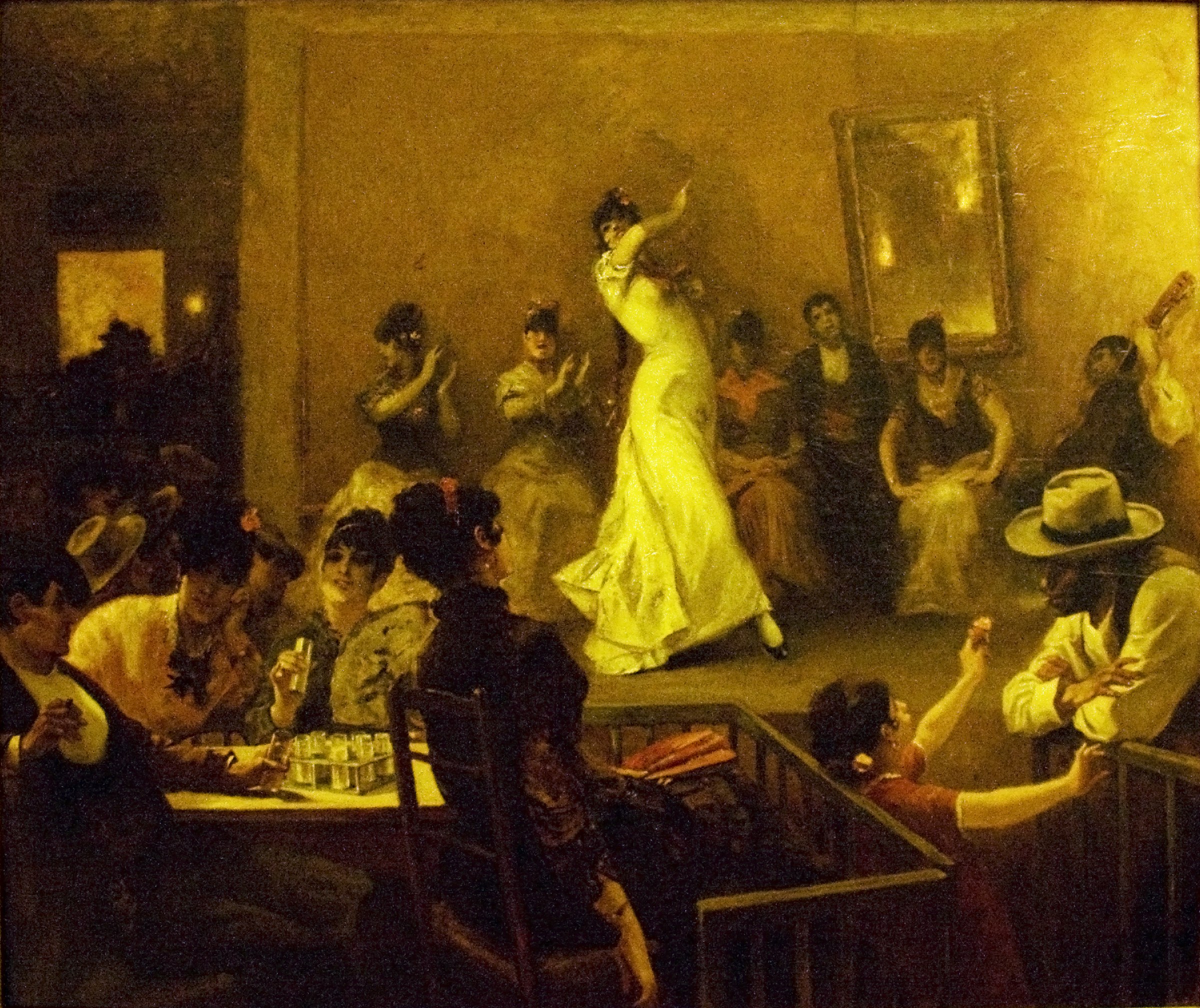 A woman in a pale dress dances on a raised platform, surrounded by onlooking men and women in dark clothing in a warm-lit interior space.