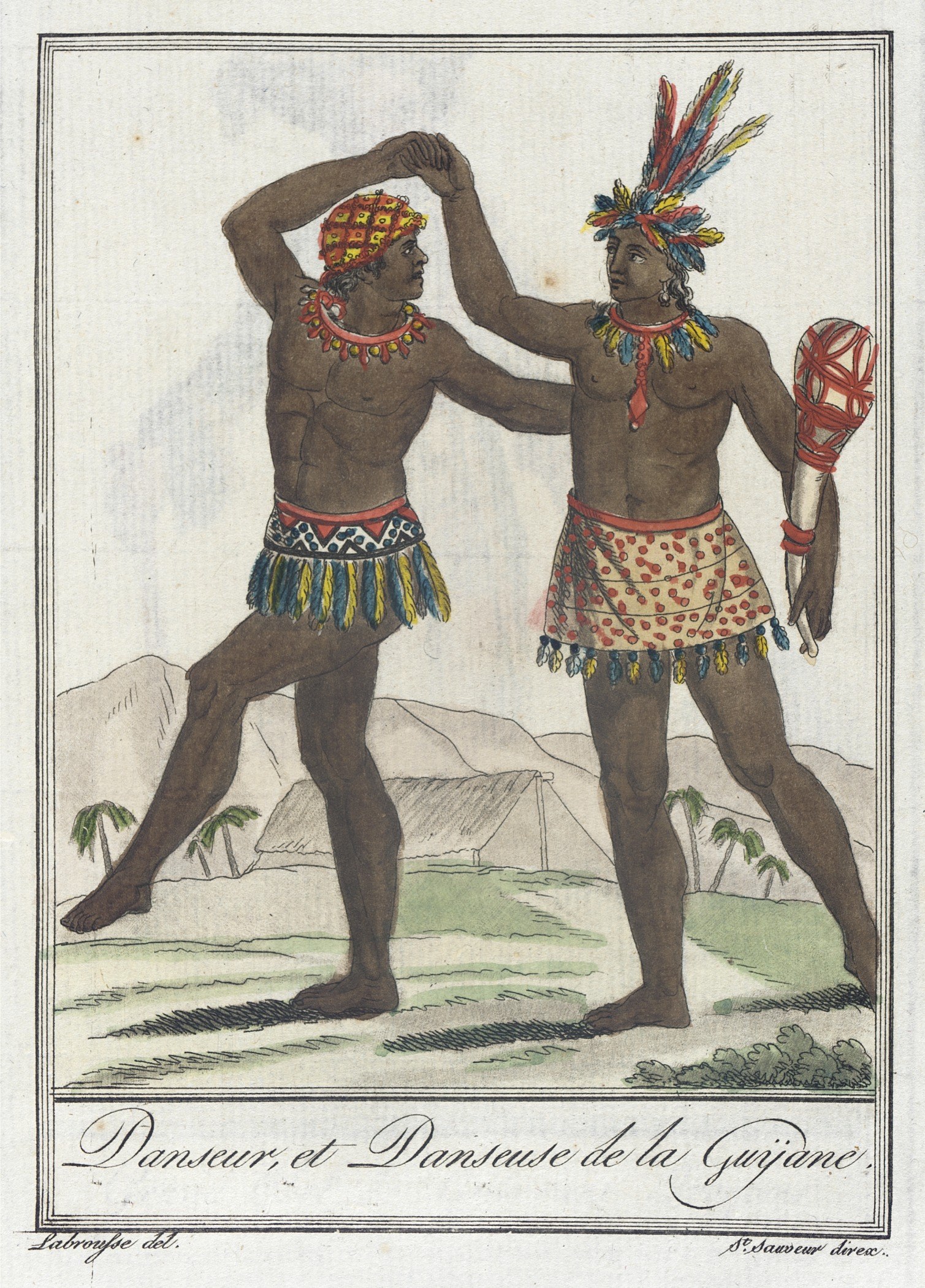 Two bare-chested men in feathered headdresses and patterned skirts stand facing each other in a tropical setting, posed in conversation.