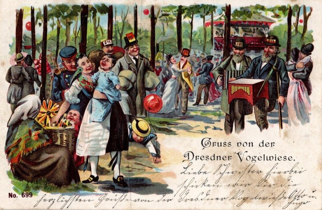Crowded festival scene at a tree-lined garden with formally dressed people, street musicians with a mechanical organ, and colored balloons strung between