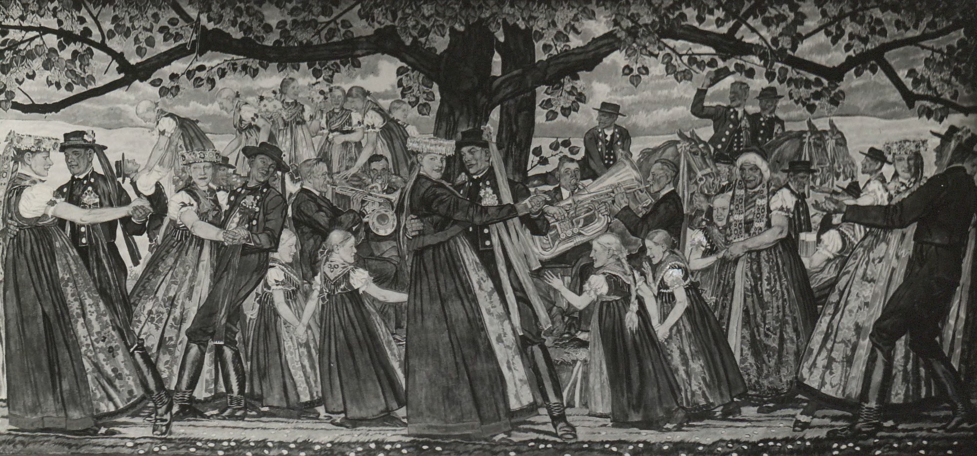 Large gathering of Silesian folk dancers and musicians beneath an ancient tree, wearing embroidered regional costume and holding traditional instruments.