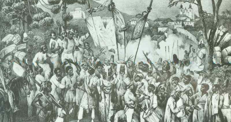 Engraving of crowded outdoor festival with figures in white dress gathered around a central pole; church visible on hillside in distance.