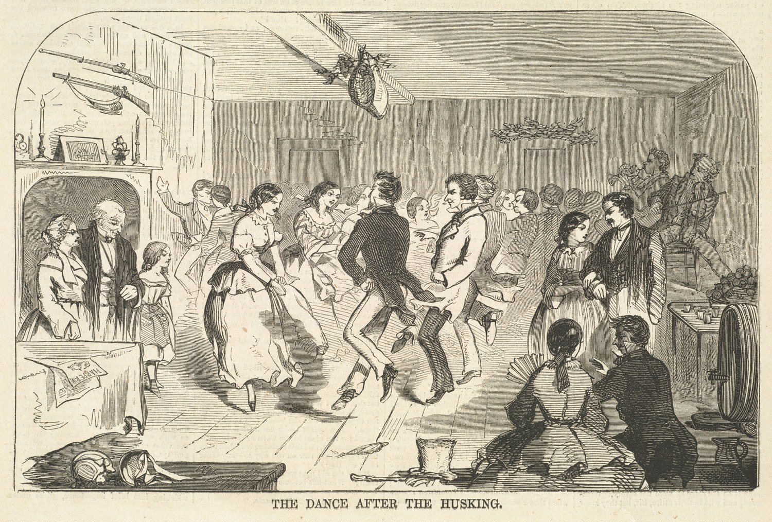 Wood engraving of a crowded barn or hall where men and women in 1850s dress dance and socialize on a floor littered with corn husks.