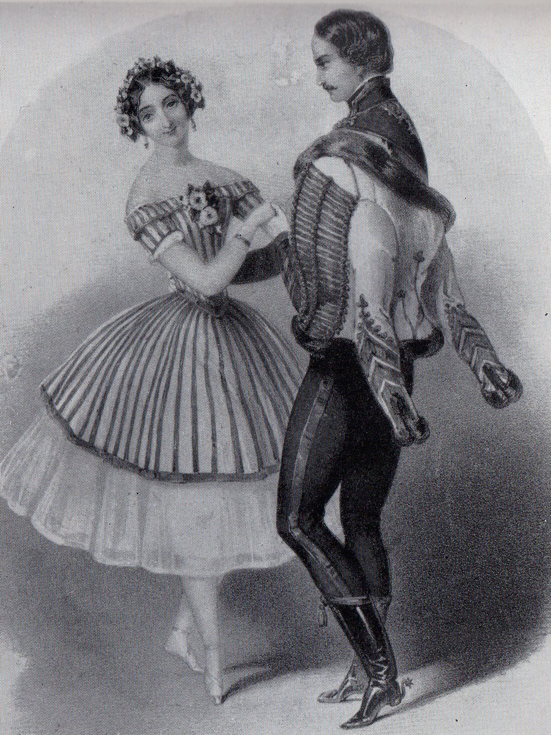 A man in a dark military coat and a woman in a white Romantic-era ball gown stand formally posed together against a plain background.