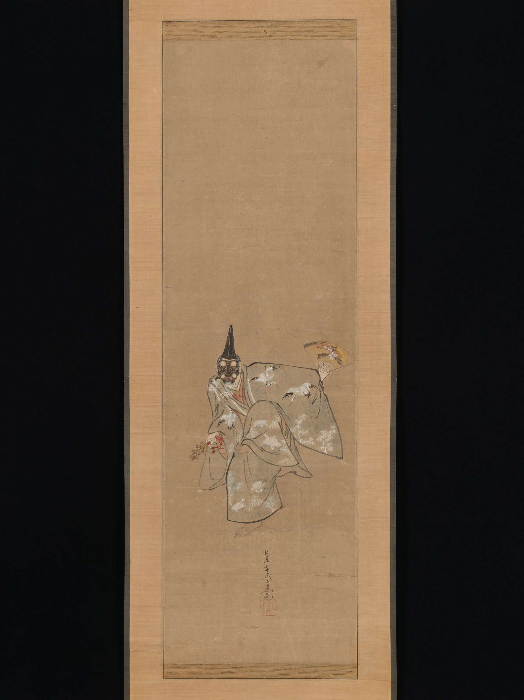 A masked figure in layered robes leans forward in a deep bow, arms extended; tall pointed black mask; ink and color on hanging scroll.