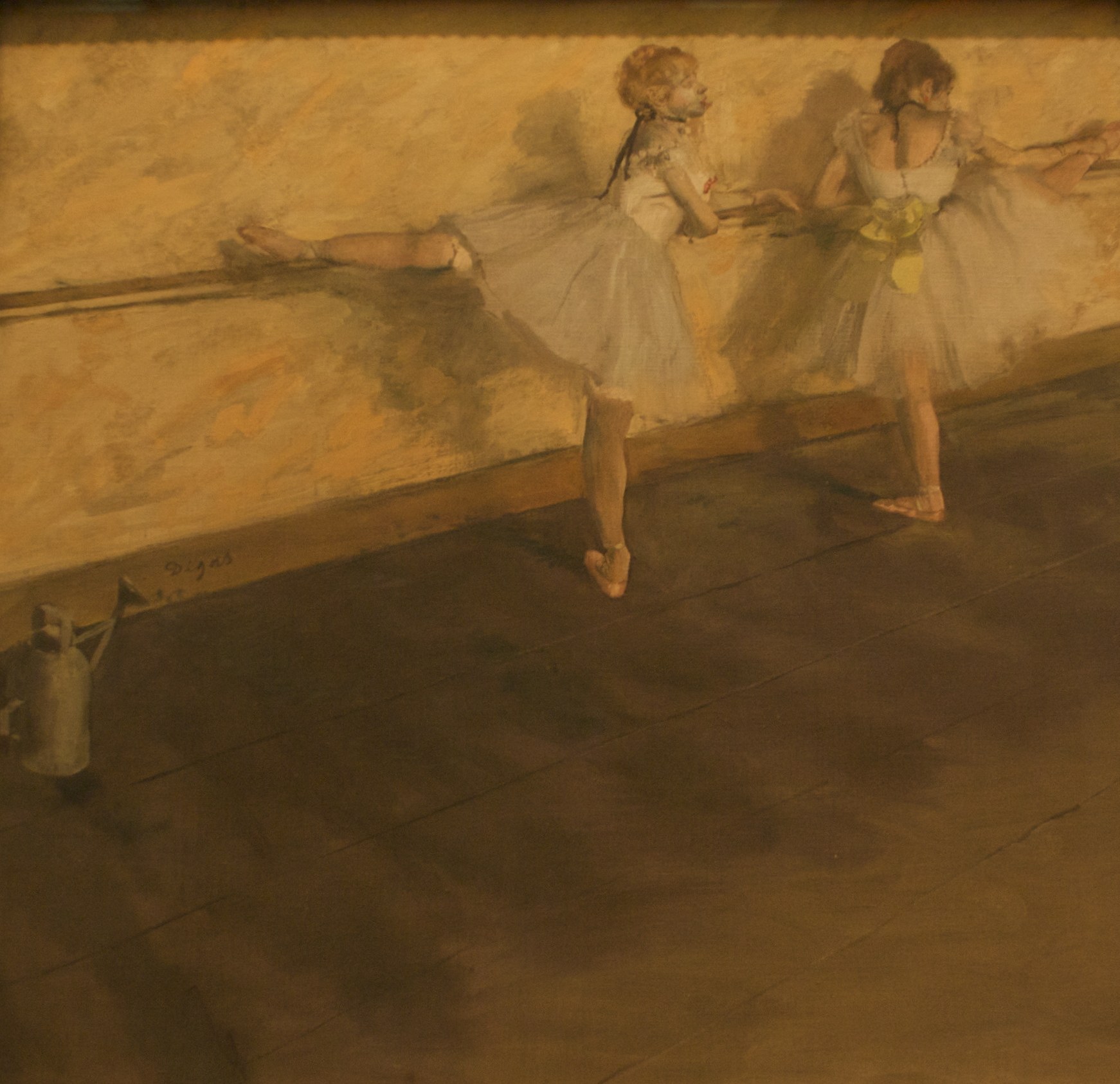 Two young ballet dancers in pale tutus stand at a wooden barre, practicing exercises in a warm-lit studio.