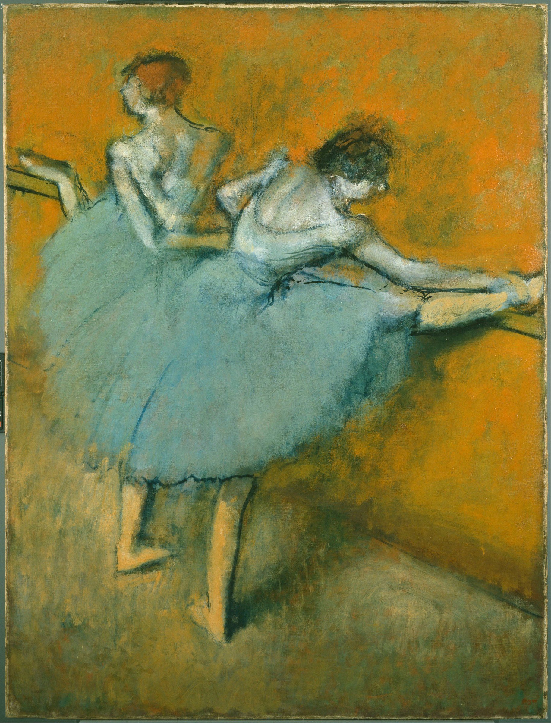 Two ballet dancers in pale blue practice dresses at a wooden barre; one stretches forward, the other stands upright against a warm ochre background.
