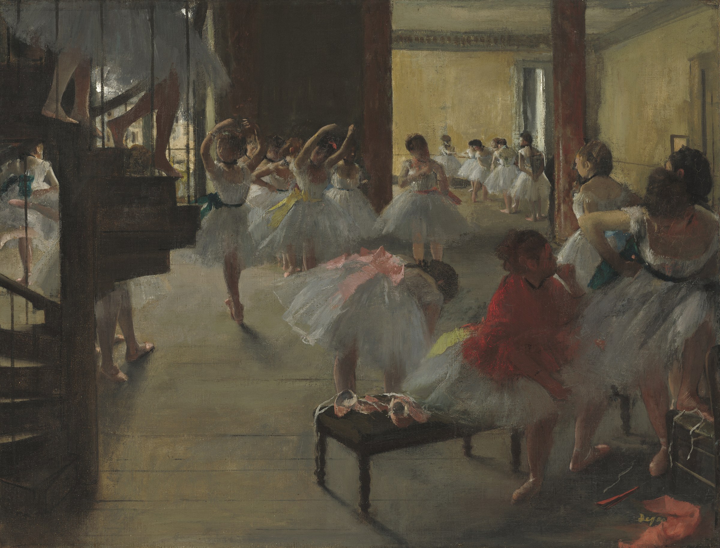 Multiple dancers in white tutus practice in a high-ceilinged studio; a woman in red oversees from the side.