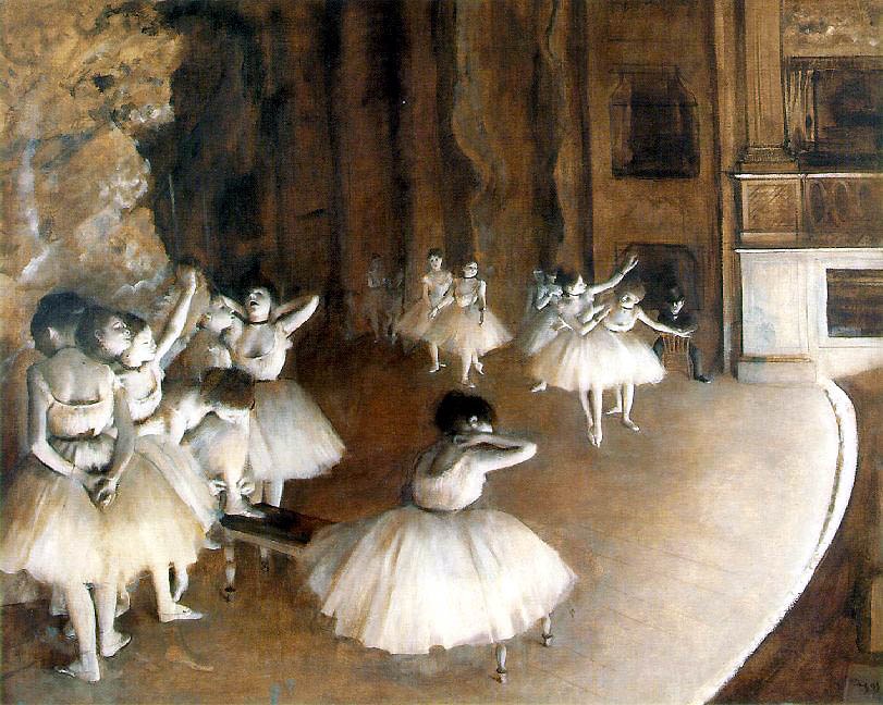 Young female ballet dancers in white tutus scattered across a wooden studio floor during class, some in arabesque or bent positions, with a dark-clothed
