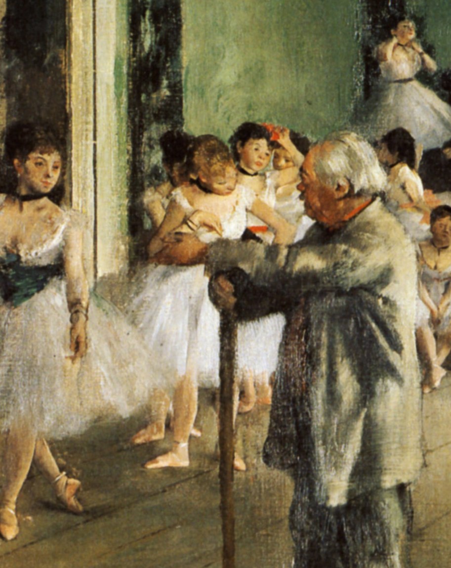 An elderly ballet instructor in a dark suit adjusts the arm position of a young female student in a white practice dress while other students observe in a
