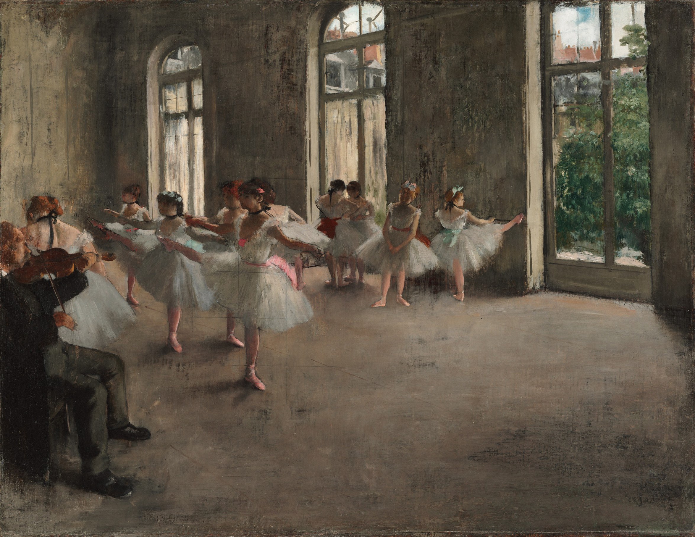 Ballet dancers in tutus practice in a sunlit studio while a violinist provides accompaniment.