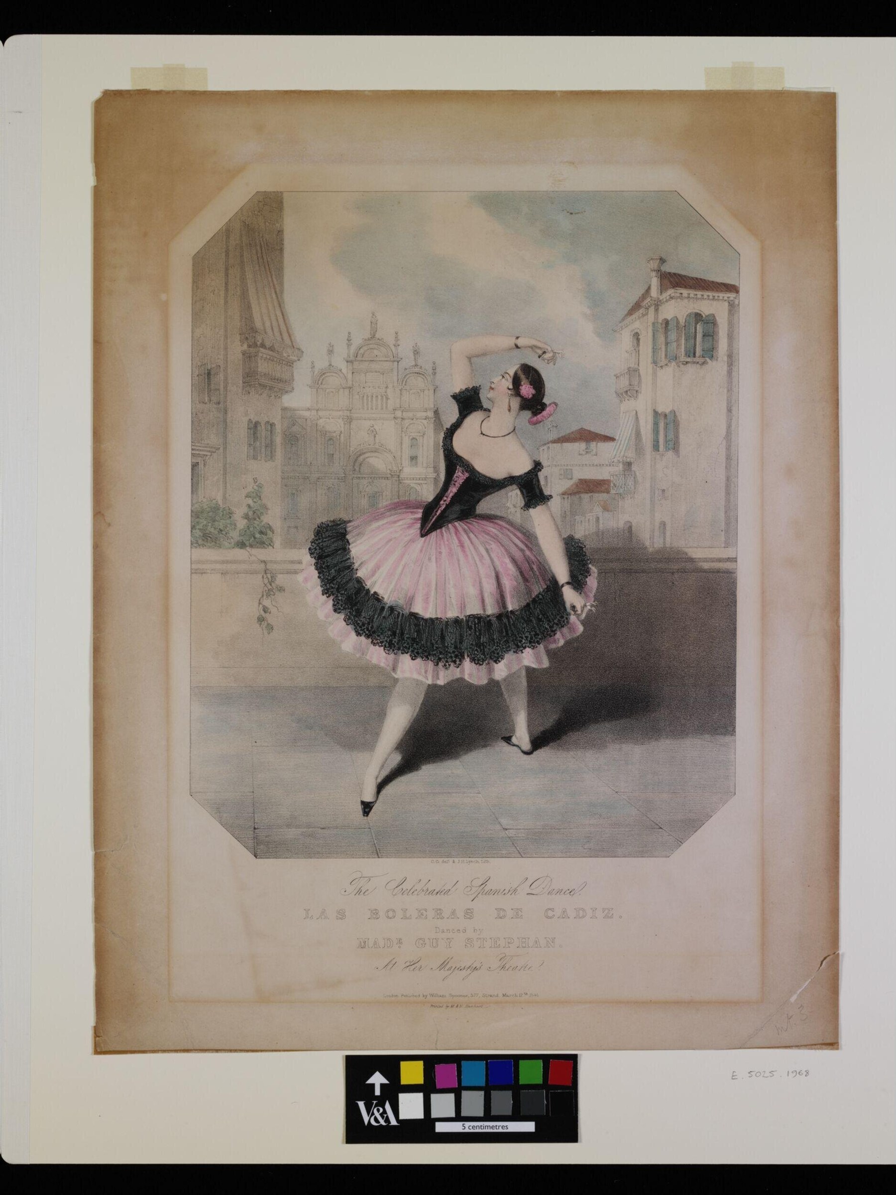 A young female dancer in a pink silk skirt with black lace trim stands en relevé before a cathedral, holding a parasol, in an arabesque-like pose.