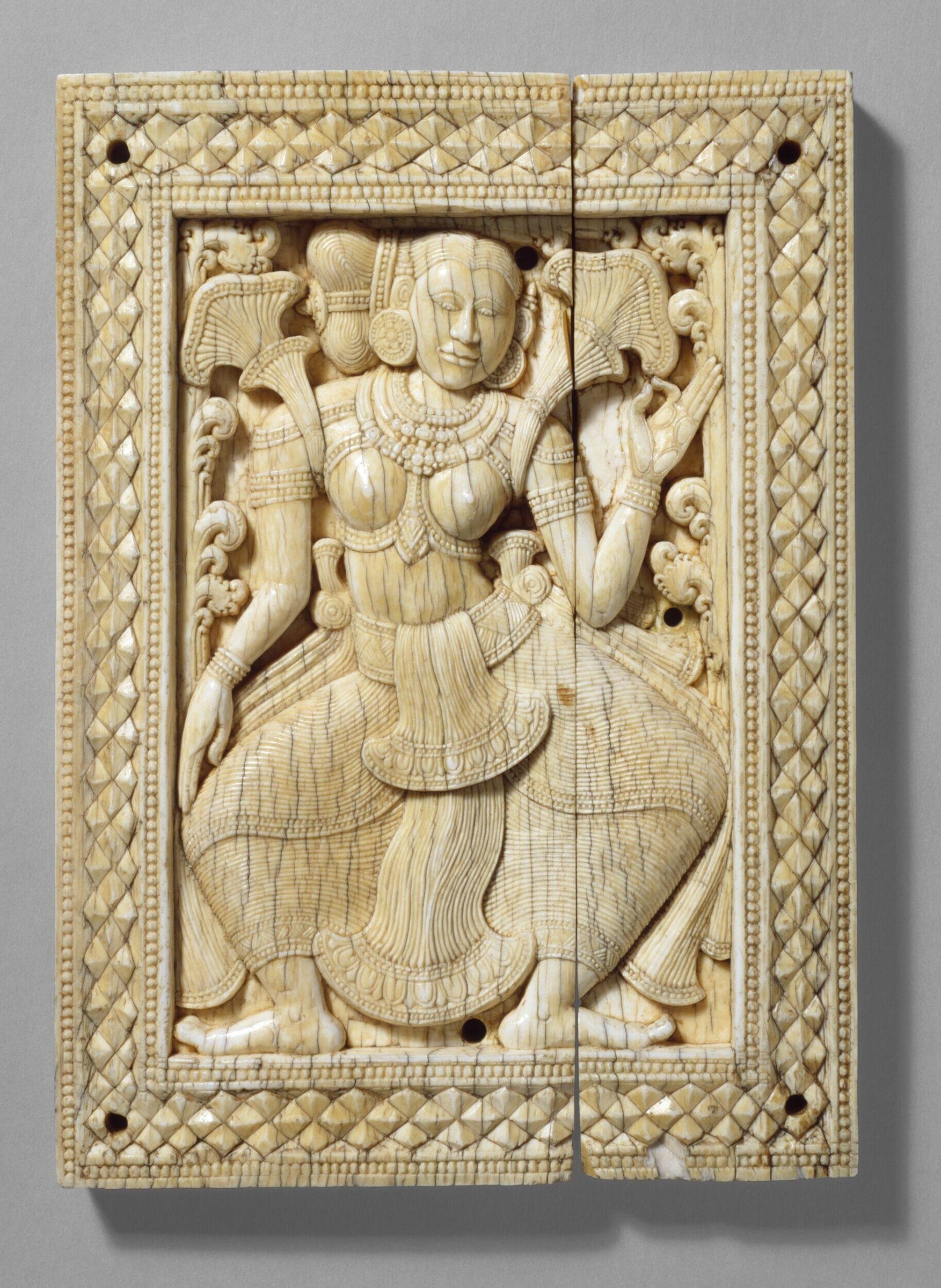 Two-panel ivory relief carving of an ornately dressed female figure in formal pose, surrounded by scrollwork and attended by smaller figures.