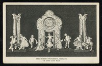 A theatrical stage tableau showing performers in pale costumes arranged symmetrically around a large ornate clock, flanked by classical columns.