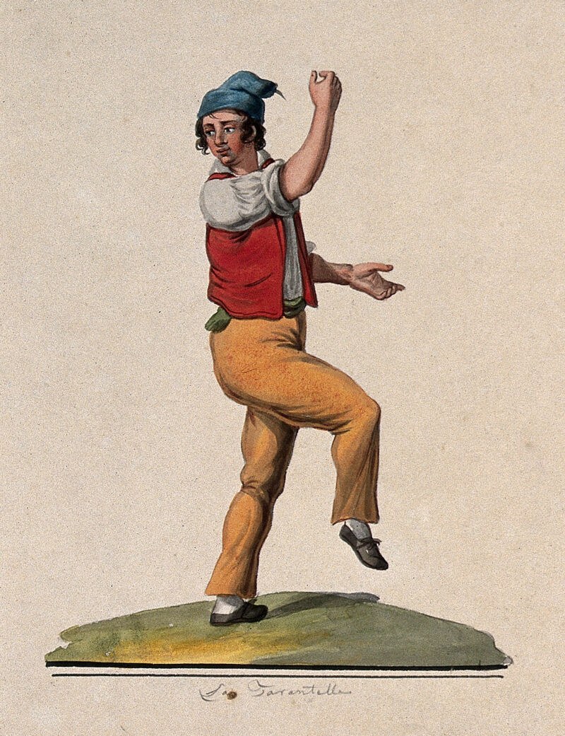 A young man in blue cap and red tunic leaps mid-tarantella, right leg raised, arms open, on a green stage line.
