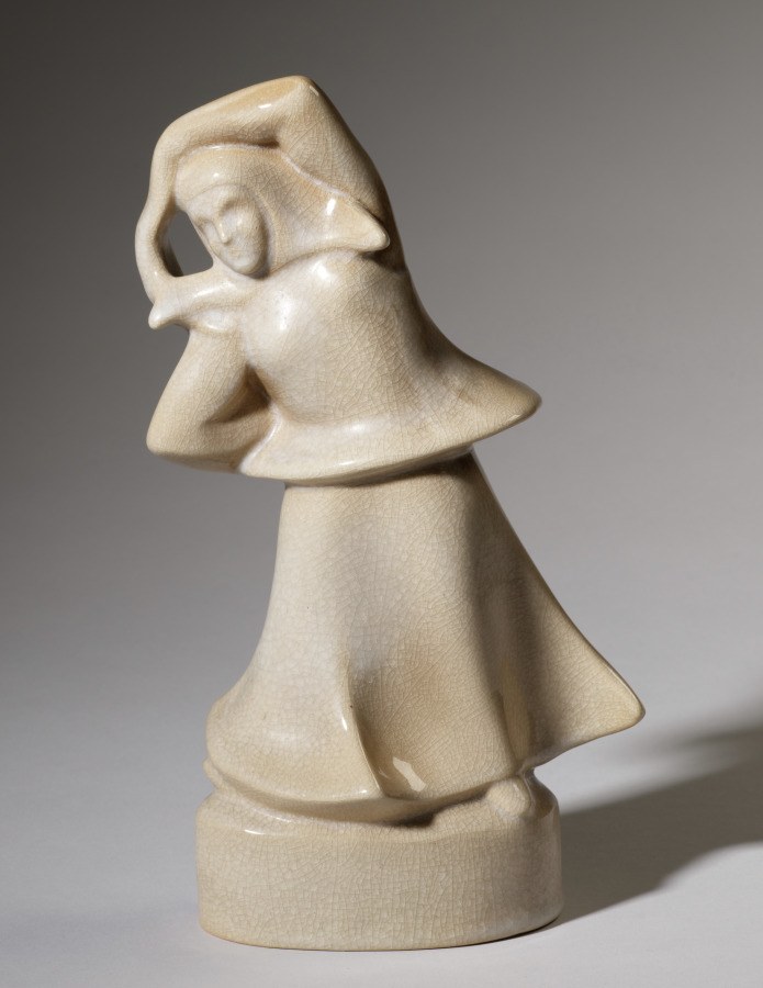 Cream-colored stone sculpture of an abstracted female figure with head tilted sharply backward, draped garment, mounted on cylindrical base.