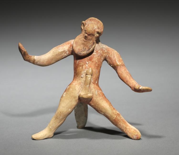 Terracotta figurine of a male satyr in a dynamic lunging pose, left arm raised, head tilted back, rendered in warm tan clay with visible age patina.