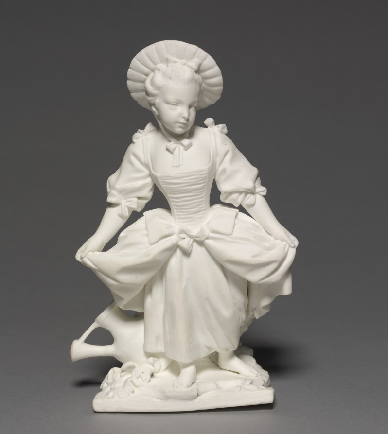White marble figure of a young woman in 18th-century court dress, standing in elegant repose with downward gaze and graceful posture.