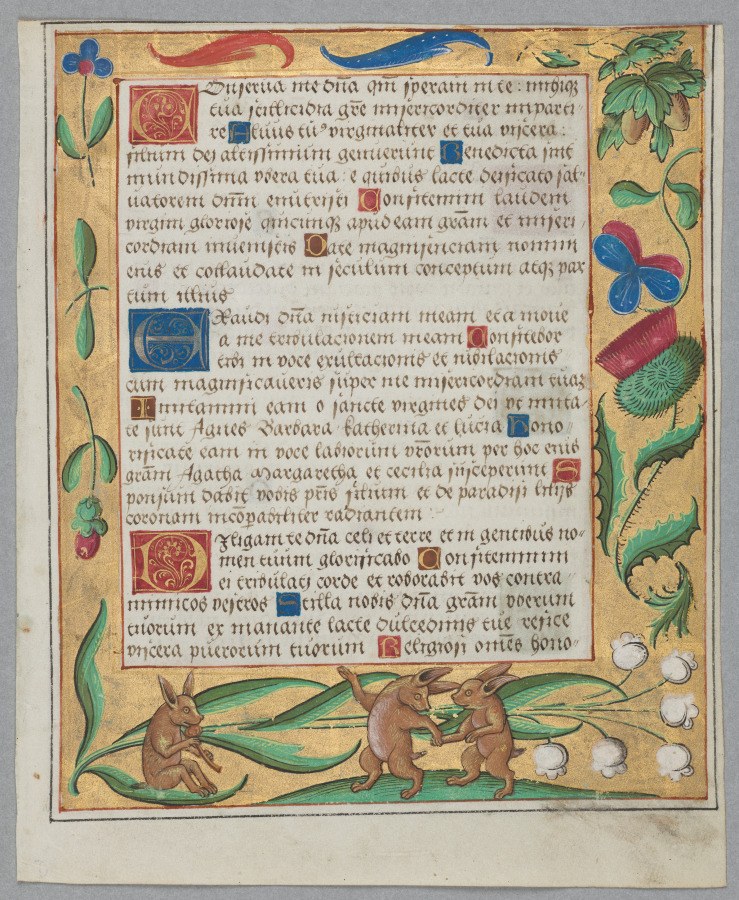 Two rabbits in mirrored jumping posture in the margin of a medieval illuminated manuscript page.