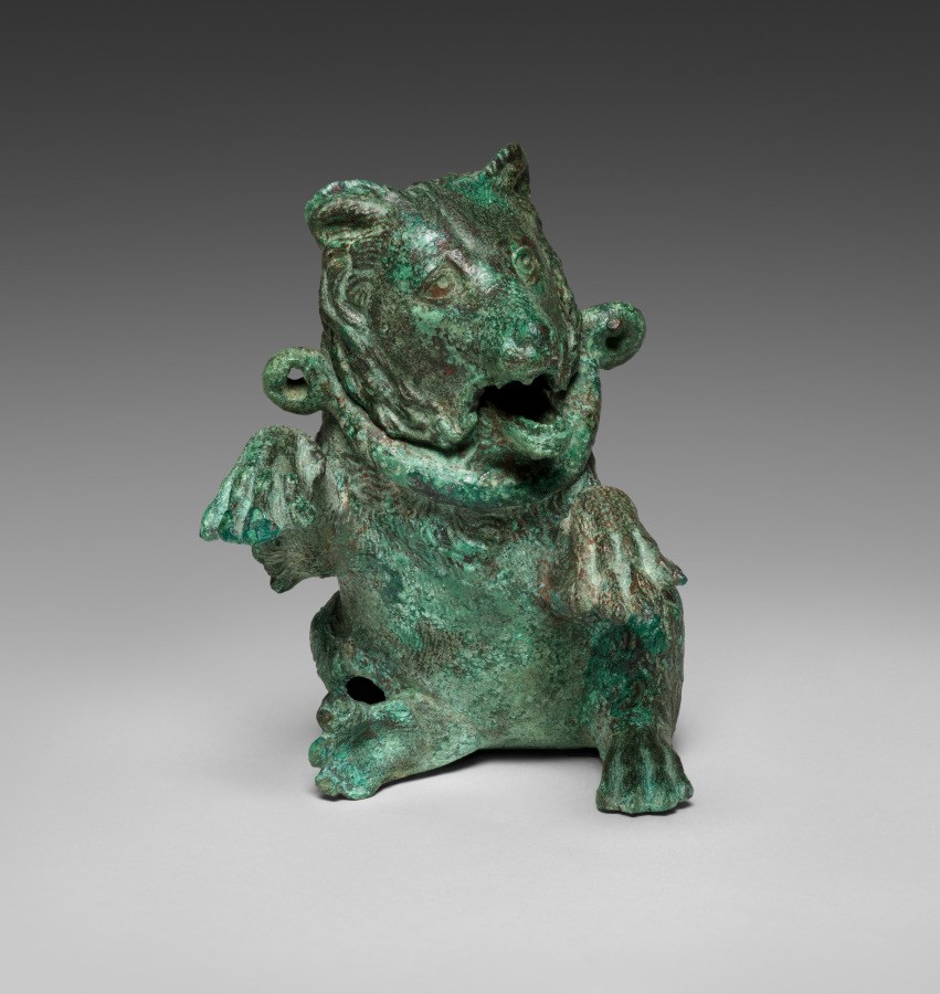 Green-patinated bronze vessel cast in the shape of an upright dancing bear with head thrown back and mouth open.