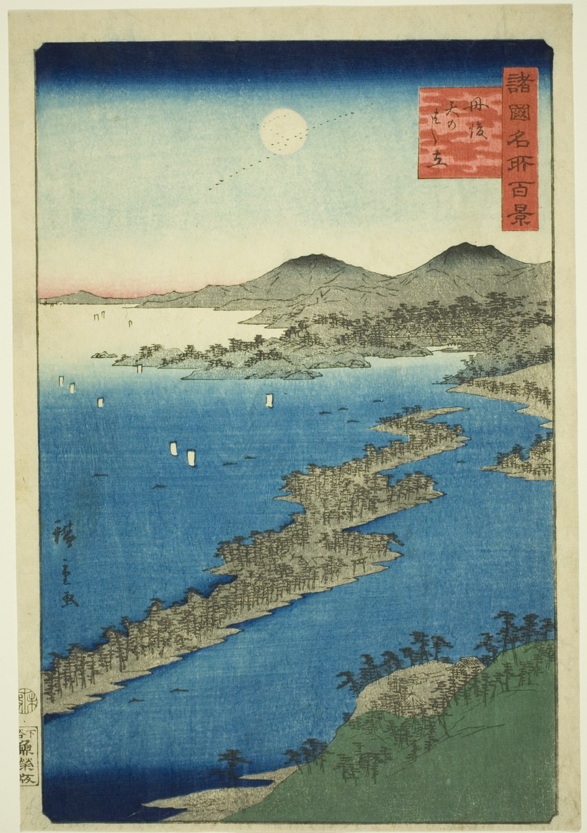 Aerial view of a forested sandbar dividing blue water and mountains under an indigo sky with moon trail.