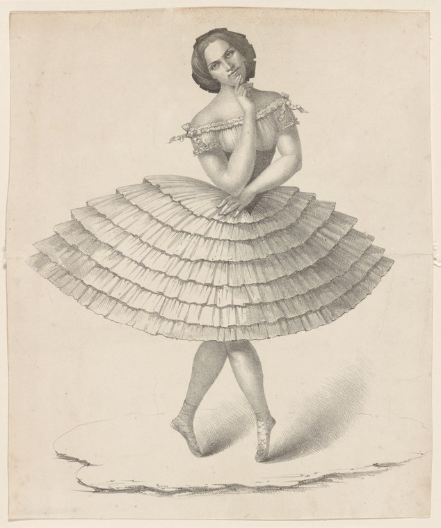 A woman in a short-sleeved dress with an enormously full pleated skirt stands with her left arm raised to her head, tilted back, in a composed theatrical pose.