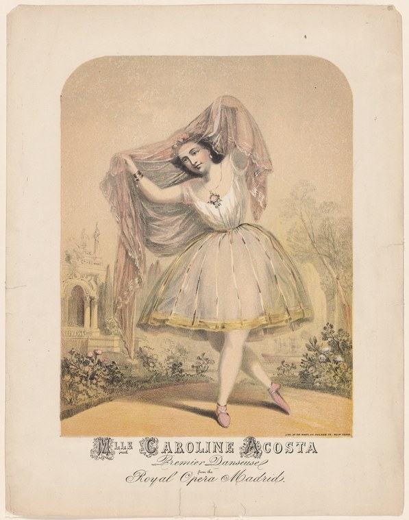 A young woman in a pale tulle skirt and veil stands on the balls of her feet in a garden with classical ruins, one arm raised gracefully.