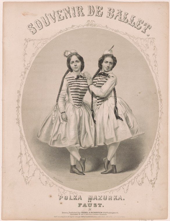Two identically dressed young women in striped bodices and feathered headdresses stand mirrored in an ornamental oval frame.