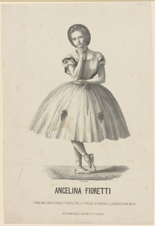 A young woman in a white ball gown and pointe shoes stands facing the camera, hand raised to her chin, wearing a tiara.