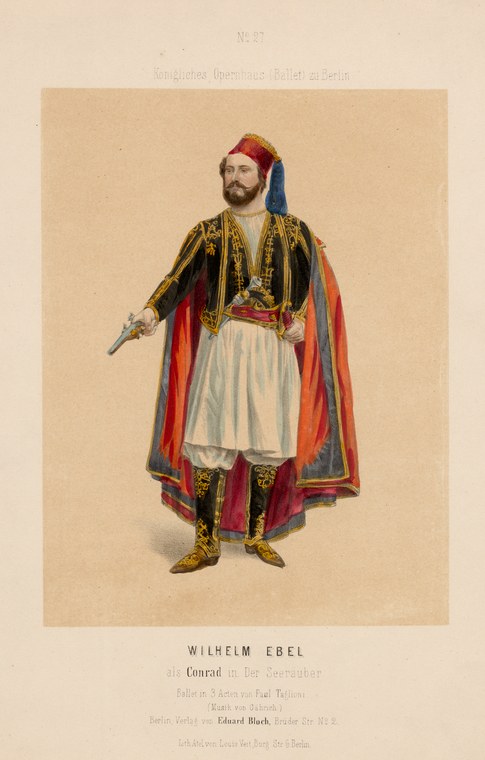 A bearded man in orientalist pirate costume with embroidered jacket, white skirt, red cape, and red cap, standing with a dagger, against a neutral background.