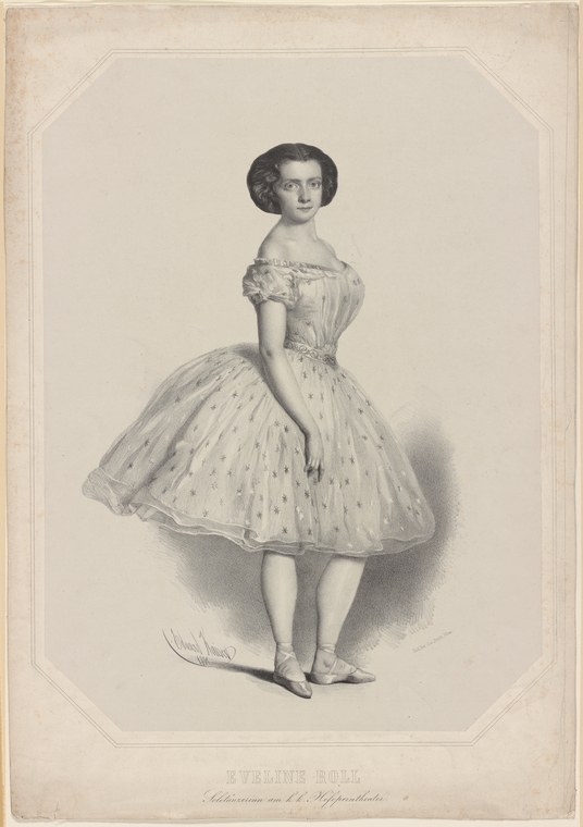 A young woman in a full-skirted Romantic ballet dress with an off-shoulder neckline stands alone in a portrait, facing slightly right.