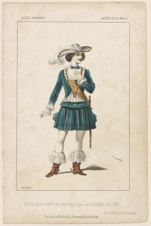 A man in 18th-century courtly dress stands at rest: dark green jacket, gold-trimmed waistcoat, pleated skirt, white ruffled cuffs, brown heeled boots, and a