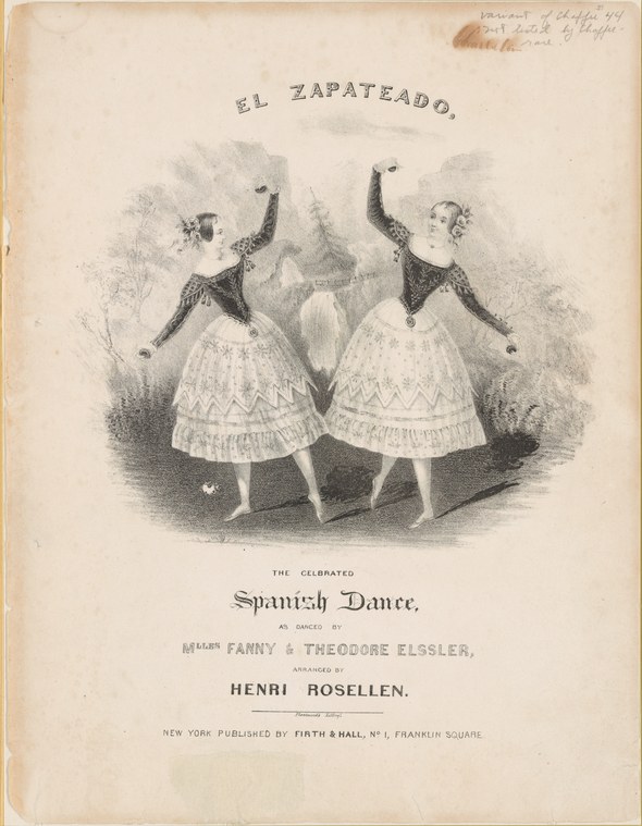 Two women in black jackets and white tiered skirts pose identically with raised right arms and extended left arms.