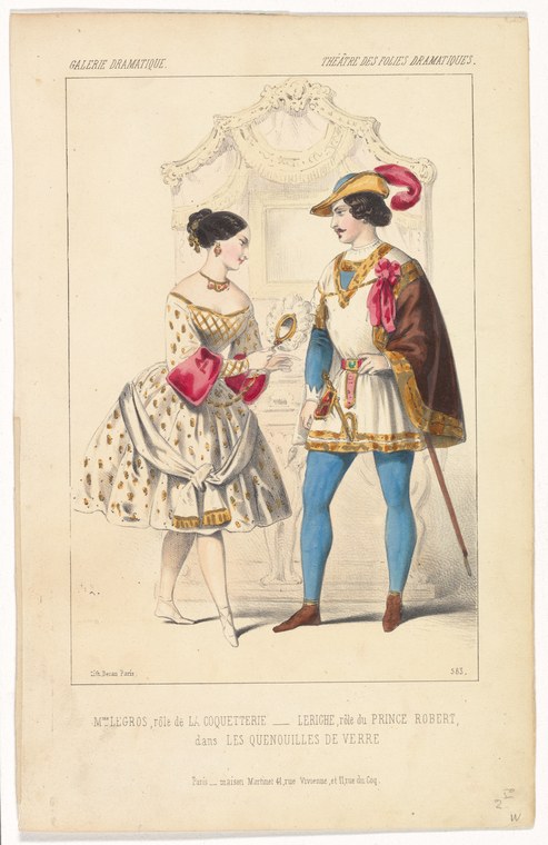 Two figures in ornate theatrical costume stand in conversation in a palace interior; the man wears a feathered headdress and tunic, the woman a patterned dress