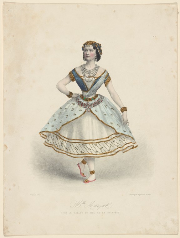 A woman in a Romantic ballet costume stands in a graceful pose, wearing a short skirt, jeweled headdress, and ornate Eastern-inspired overdress.