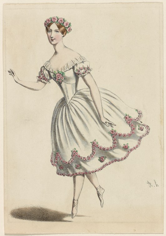 Female ballet dancer in pale tulle skirt with pink roses, en relevé on one leg, arm raised expressively, wearing floral wreath and crown.