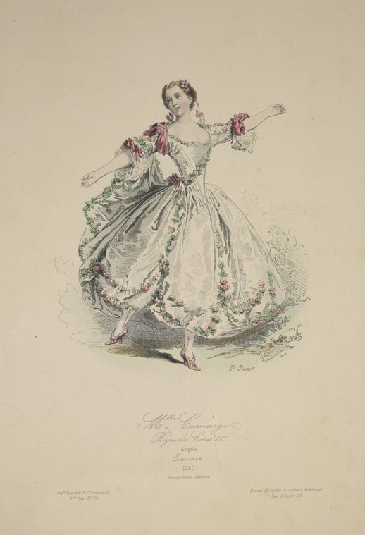 Woman in elaborate pale silk gown with flower garlands, one arm extended, standing in formal upright posture against plain background.