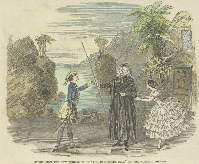 Three figures in theatrical costume on a tropical shore: a uniformed naval officer, a cloaked warrior, and a woman in an elaborate white ball gown.
