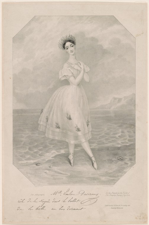 A young woman in a pale muslin dress stands alone on a beach, arms raised in a graceful ballet pose, one leg extended.