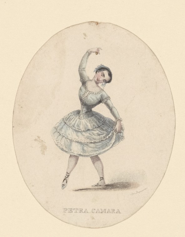 A young woman in a light tutu stands en pointe with her right leg extended behind her, arms raised in a ballet pose.
