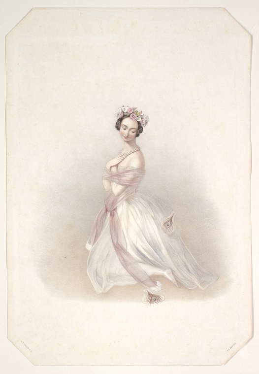 A ballerina in a white tutu and off-shoulder pink bodice stands in an elegant pose on pointe, with a wreath of flowers in her dark hair.