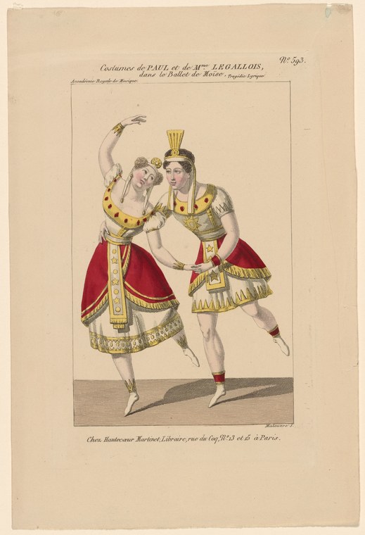 Two dancers in gold and red Egyptian-style costumes pose in contrapposto on a neutral stage, one with arm raised holding a curved object.