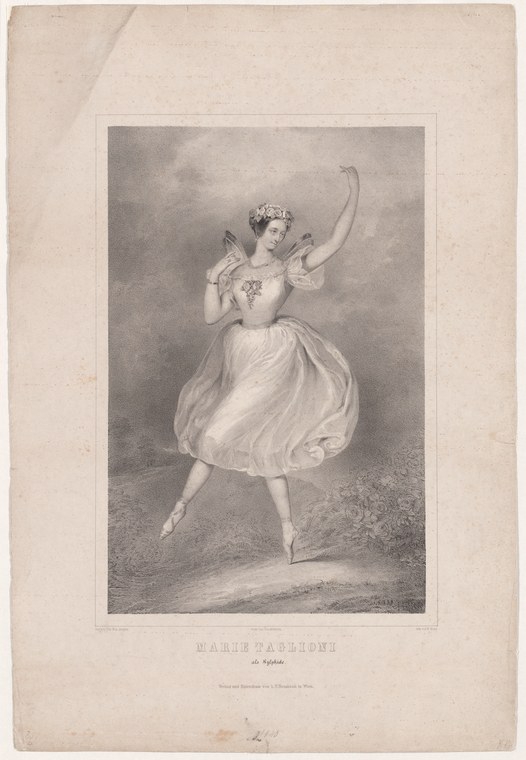 A young woman in a white tulle dress and floral crown performs a weightless leap, one leg extended high, arms raised, gazing upward.