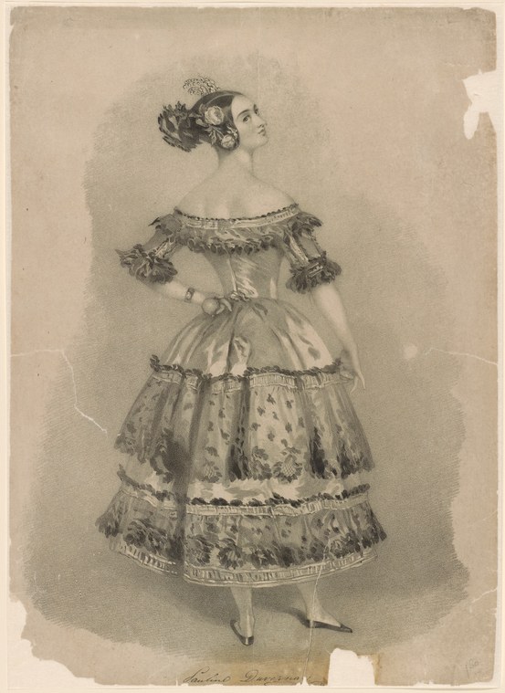 Woman in Romantic-era ballet costume with off-shoulder bodice and short, multi-tiered skirt, standing in three-quarter profile with poised classical carriage.