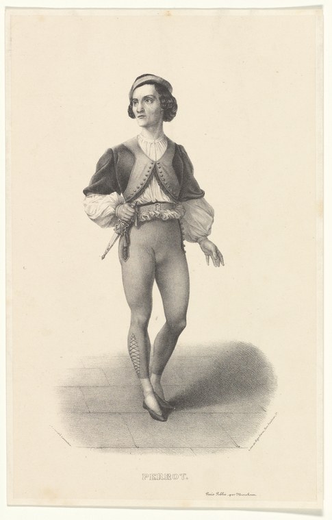 Male ballet dancer in Romantic-era costume standing in composed pose: dark jacket, white tights, soft slippers.