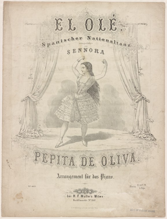 Woman in tiered Spanish dance costume performs on stage, both arms raised, caught mid-movement within ornate theater curtains.