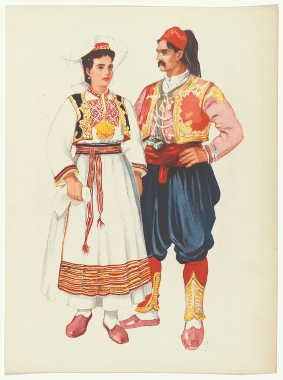 Two figures in richly embroidered traditional Yugoslav dress stand formally posed against a neutral background.