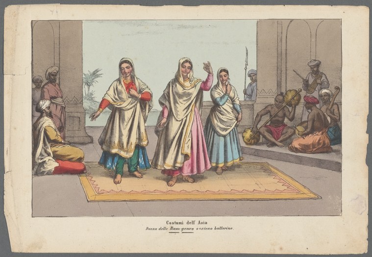 Three women in draped white and colored garments with head coverings stand on a raised platform in a columned hall, arms raised in formal gestures. Musicians