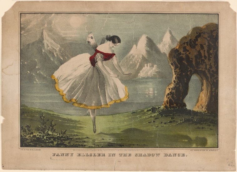 Woman en pointe in white tulle skirt with crimson sash stands in mountain landscape with snow-capped peaks.