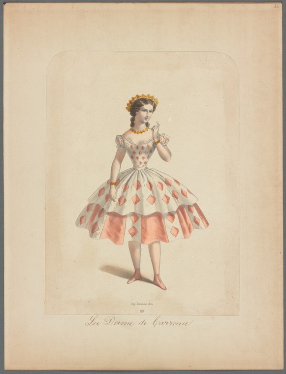 A woman in a romantic-era ballet costume with a tiered tutu decorated with coral diamond patterns stands in a classical pose on pointe shoes.